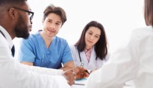 Doctors interacting at meeting in conference room