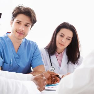 Doctors interacting at meeting in conference room