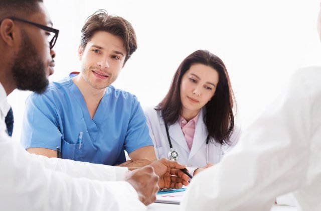Doctors interacting at meeting in conference room