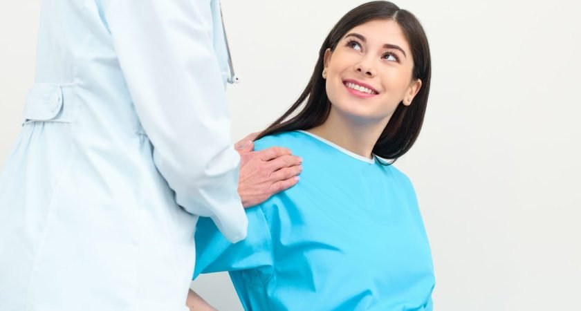 obstetrician gynecologist supporting pregnant woman before parturition