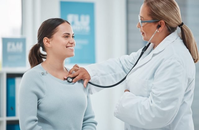 Shot of a doctor examining a patient with a stethoscope during a consultation in a clinic