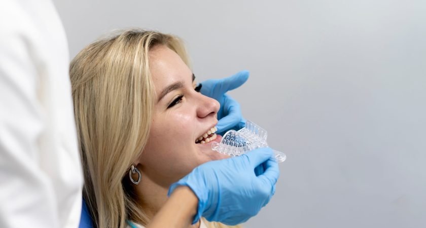the otrhodontist making teeth impression mold in a plastic tray, orthodontic treatment concept